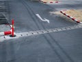 White Turn-Left Traffic Arrow Symbol on Asphalt Road