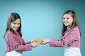 White twin sisters fighting for handmade masque Royalty Free Stock Photo