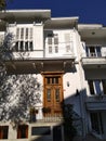 White two floor mansion with wooden brown enter door