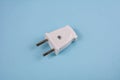 White two pronged plug on a blue background