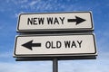 White two street signs with arrow on metal pole with word new way and old way