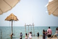 White Umbrella and chair on the beach for support traveler at Pattaya beach of Thailand. The outdoor soft sandy beach of Pattaya