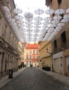 White umbrellas hanging above a street in historical centre of Bratislava