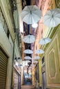 White umbrellas hanging above the street