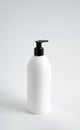 White unbranded bottle with a black dispenser isolated on white background. cosmetic packaging mockup with copy space