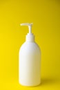 White unbranded dispenser bottle isolated on yellow background