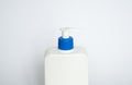 White unbranded plastic dispenser pump bottle on white background. Cosmetic package mockup, liquid soap flacon, hand Royalty Free Stock Photo
