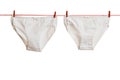 White underpants on a red and white rope with red clothespins. Royalty Free Stock Photo