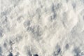 White uneven snow texture with embossed shadows. Abstract background with snowy surface in spring time