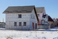 White unfinished brick house on a building site in the snow Royalty Free Stock Photo