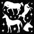 White unicorn silhouettes set with stars on black backdrop Royalty Free Stock Photo