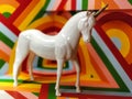 White unicorn statue and colorful 70s background