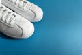 White unisex sneakers on classic blue background