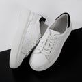 White unisex sneakers, on white and black background