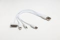 White universal charging cable, adapter with micro USB, usb connectors for different models of phones and devices on a white Royalty Free Stock Photo