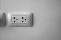 White universal electricity sockets plug on a white wall. Royalty Free Stock Photo