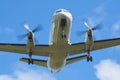 White unmarked plane on approach. Propeller. Royalty Free Stock Photo