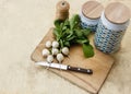 White unusual fresh organic radishes with kitchen appliances on wooden cutting board
