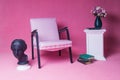 White upholstered chair on a pink background