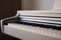 White upright piano. Classic piano keyboard with black and white keys. Royalty Free Stock Photo