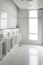 White urinals in clean men public toilet room empty Royalty Free Stock Photo