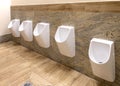 White urinals in men`s bathroom, the design of white ceramic urinals for men Royalty Free Stock Photo