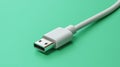 White usb cable lying on a vibrant green background for technology and connectivity concepts Royalty Free Stock Photo