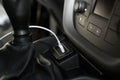 White USB charging cable plugged in inside modern car Royalty Free Stock Photo