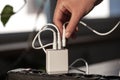 White USB charging for gadgets on a blurred background of the room, close-up. Royalty Free Stock Photo