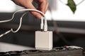 White USB charging for gadgets on a blurred background of the room, close-up. Royalty Free Stock Photo
