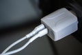 White USB charging for gadgets on a blurred background of the room, close-up. Royalty Free Stock Photo