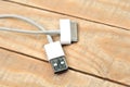 White usb mobile charging cable on wood table Royalty Free Stock Photo