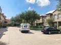 White USPS truck stops at apartment building complex on sunny da