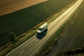 A white van driving down a country road. Aerial view