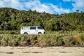 White van passing through the plain with trees and greenery background Royalty Free Stock Photo