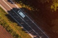 White van on the road, top down aerial view from drone pov