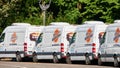 White vans from the fleet of the car rental company Sixt park at the side of the road Royalty Free Stock Photo
