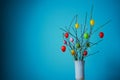White vase with a branch decorated with Easter eggs Royalty Free Stock Photo
