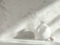 White vase and egg on marble surface with shadows Royalty Free Stock Photo