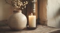 White Vase With Flowers and Lit Candle