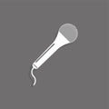 Portable microphone. White vector icon on a gray background with a shadow. Royalty Free Stock Photo