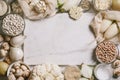 White vegetables and mushrooms, rice, quinoa, legumes, white peppercorns, coconut oil around a white marble cutting board on a Royalty Free Stock Photo