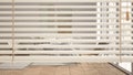 White venetian blinds close up view, over modern scandinavian bedroom with double bed and armchair, interior design, privacy Royalty Free Stock Photo