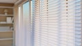 White Venetian blinds with sunlight