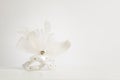 White venetian mask on a white background and a white table with copy space Royalty Free Stock Photo