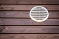 White ventilation grill on a wooden background, building facade