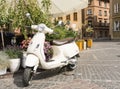 White Vespa Piaggio, Italian designed scooter, parked near cafe Royalty Free Stock Photo