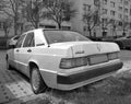 White veteran vintage classic old white sedan car Mercedes Benz 190E parked Royalty Free Stock Photo