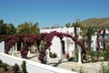 White villas and arches of violet flowers on the territory of th