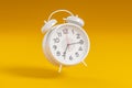 White vintage alarm clock on bright yellow color background. Time management, deadline concept. it\'s time to act